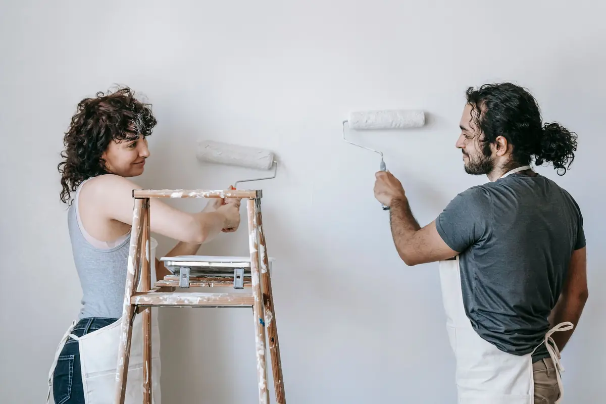 People painting a wall together — painting help in Salem